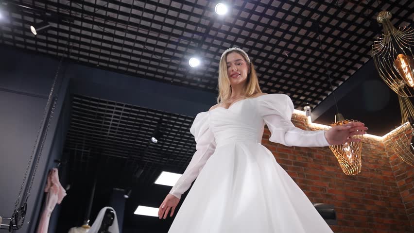 Elegant bride posing in a luxurious white wedding dress.