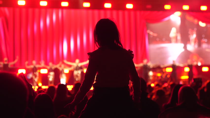 Happy little girl sit her dad shoulders. Small kid have fun live music concert. Cool neon night. Child enjoy disco party. Joyful childhood. Daughter hang out, pop show Family band fan. People raise up