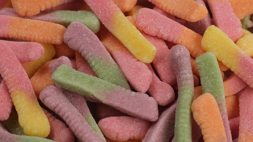 Colorful gummy candy worms close up, rotation