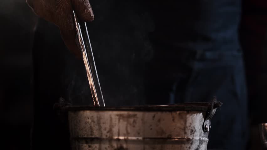 Blacksmith cooling metal in water - Powered by Shutterstock - Get 15% off with code: PIKWIZARD15