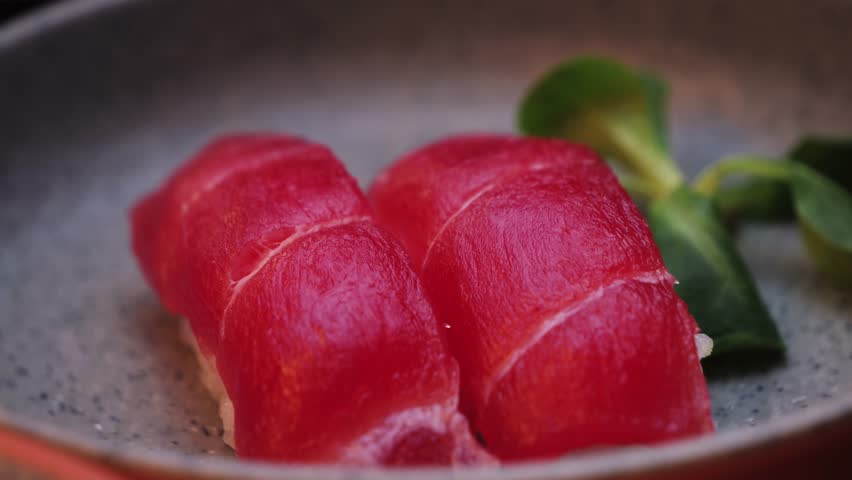 Close up of Nigiri. Sushi consisting of a hand-molded ball of rice on top of raw tuna. High quality 4k footage