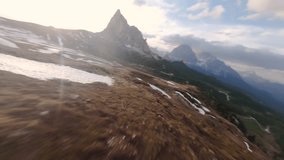 Aerial drone shot of towering peaks, rolling hills, scattered snow patches, golden sunlight casting long shadows under partly cloudy sky near Snowdonia. - Powered by Shutterstock - Get 15% off with code: PIKWIZARD15