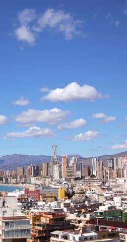 Portrait vertical time lapse footage over looking the town of Benidorm in Spain showing clouds moving over a 2 hour period over the Spanish town on the timelapse footage on a bright sunny day