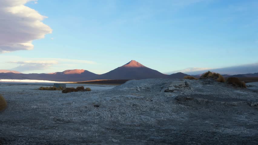 Timelapse of setting sun fading across Laguna Colorada, Bolivia, shifting light over red waters and vast landscapes of the Sud Lipez region, establishing overview