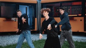 Young male hip hop dancers practicing synchronized choreography near orange food truck, perfecting dance moves with high energy and creative passion - Powered by Shutterstock - Get 15% off with code: PIKWIZARD15