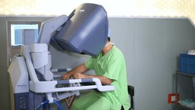 Surgeon controls medical robot remotely. Medical robot. Robot-assisted medical surgery. Minimally invasive robotic surgery. - Powered by Shutterstock - Get 15% off with code: PIKWIZARD15