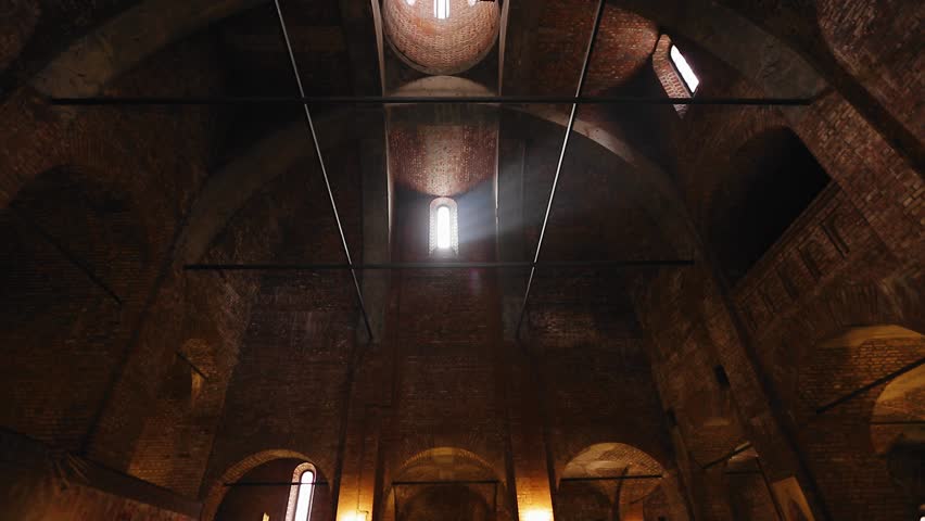 The rays of the sun penetrate through the windows of the Christian church, creating a cool atmosphere