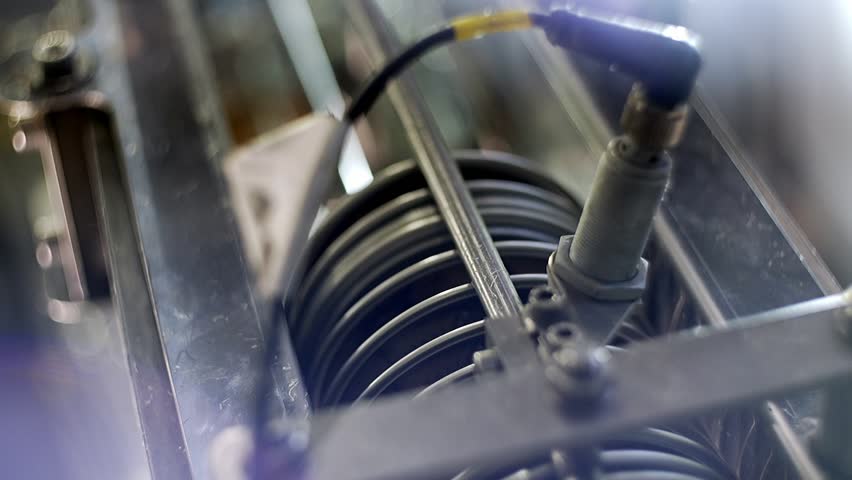 can lid production line, lids moving up, slow motion, close-up