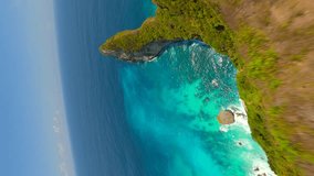 Vertical video. Cinematic FPV flight over scenic cliffs and turquoise ocean waters on Nusa Penida Island, Bali, Indonesia - Powered by Shutterstock - Get 15% off with code: PIKWIZARD15
