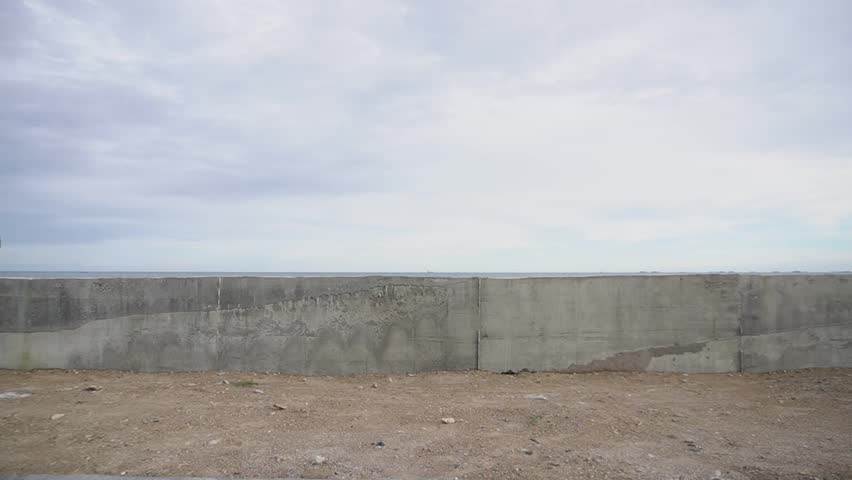 Balikpapan, Indonesia, March 26, 2025: a young man is riding a bicycle on a small road.