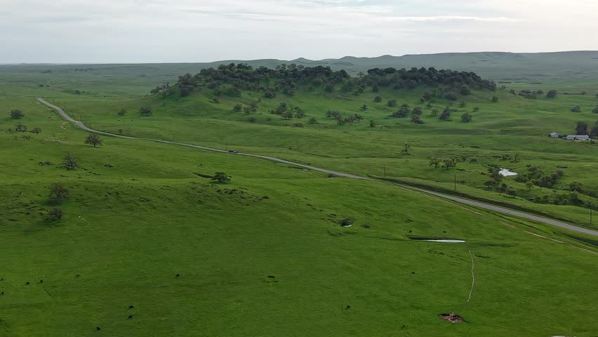 Aerial drone footage displays the diverse landscape surrounding Lake McSwain, from forests to open fields.