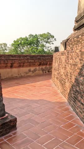 Tourists walking through historic brick structures