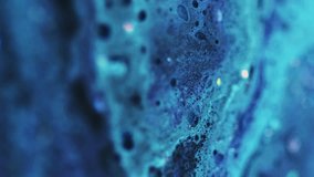 Vertical video. Glitter fluid spill. Color foam texture. Defocused blue sparkling sequin particles oil bubbles acrylic paint ink emulsion liquid flow motion abstract art background. - Powered by Shutterstock - Get 15% off with code: PIKWIZARD15