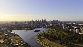 Drone video from above Albert Park in Melbourne flying toward the city with the sun starting to set on the left of the video - Powered by Shutterstock - Get 15% off with code: PIKWIZARD15