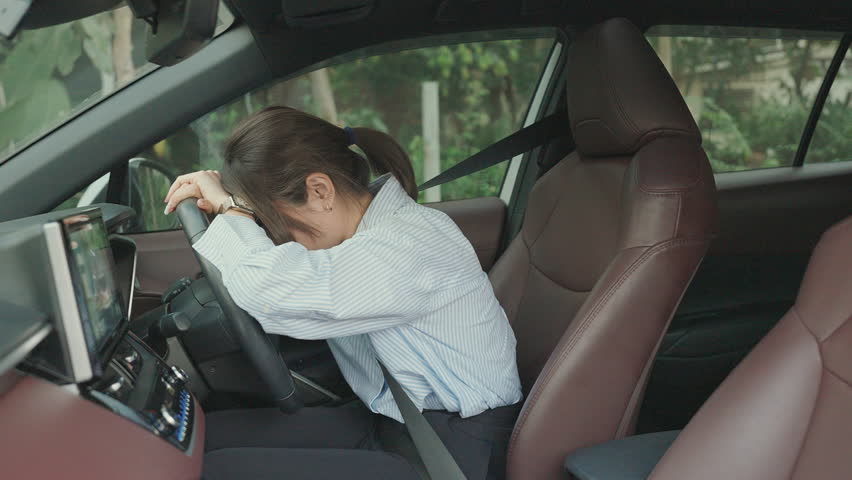 woman feeling stress and angry during drive car long time. Asian girl tired and fatigue having headache after driving car in traffic jam. Sleepy, stretching and drunk concept