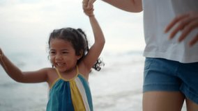 Happy young asian mother and her child walking and holding hands on the
beach and enjoy a sunset by the ocean. mom and cheerful kid girl having fun
and relaxation on a tropical seaside vacation. - Powered by Shutterstock - Get 15% off with code: PIKWIZARD15