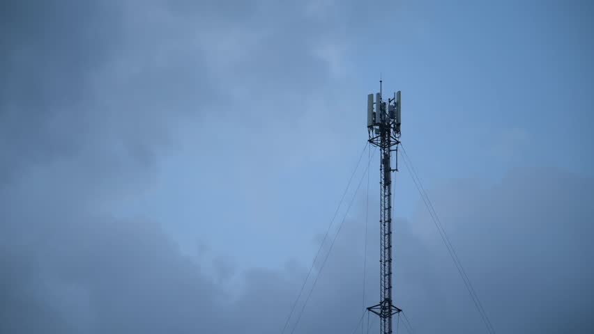 Timelapse view of tower antennas Telecommunication cell phone, radio transmitters of cellular 5g mobile and smartphones. Camera zoom in motion