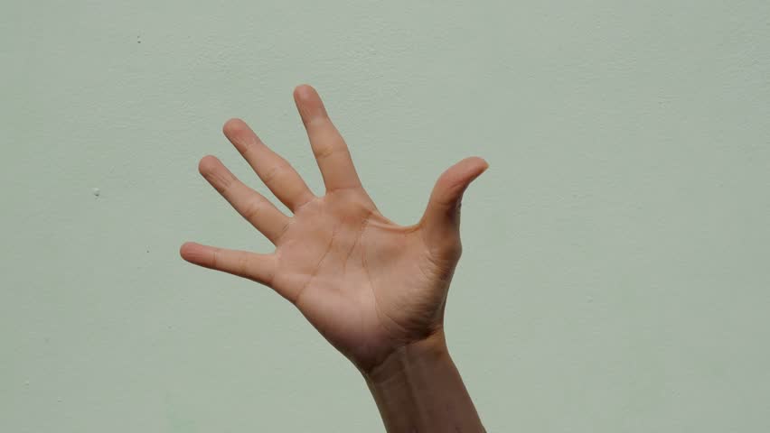 Woman exercise finger on green background, massage muscle hand outdoor with dark shadow, ideas healthy lifestyle for elderly people, medical care good health concept.