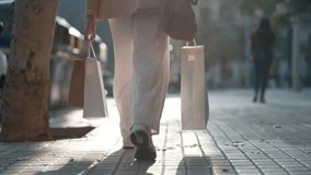 Video of close up of woman carrying shopping bags walking through the city - Powered by Shutterstock - Get 15% off with code: PIKWIZARD15