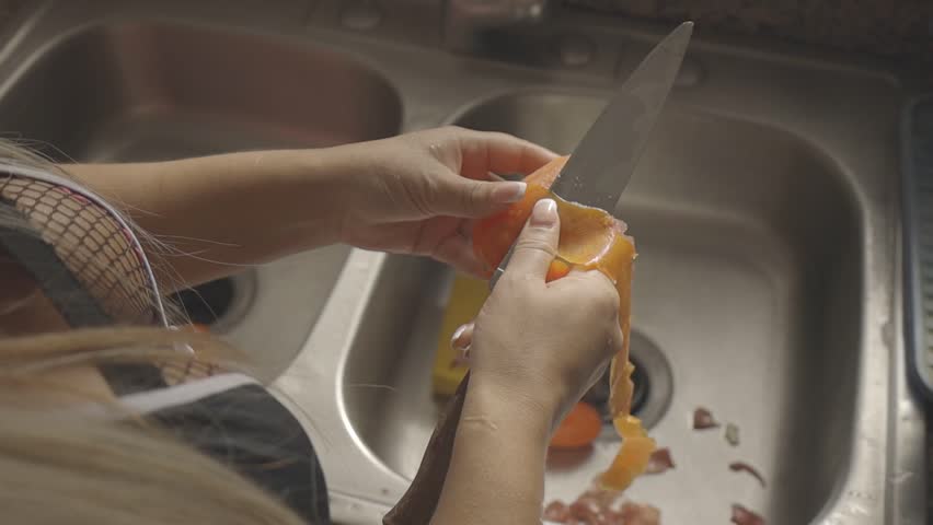 closed shot of a girl chopping tomato in the kitchen to cook salad,c-log 8bit hd video, canon eos r