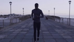 Jogging on boardwalk, man with digital data overlay animation in background. Exercise, fitness, technology, outdoors, running - Powered by Shutterstock - Get 15% off with code: PIKWIZARD15