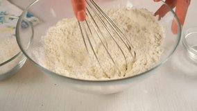 Woman hands mixing flour with baking powder using whisk cooking dough in bowl on kitchen. Ingredients recipe cuisine culinary. Homemade food, bakery. Making shortbread dough for pie or cookies. - Powered by Shutterstock - Get 15% off with code: PIKWIZARD15