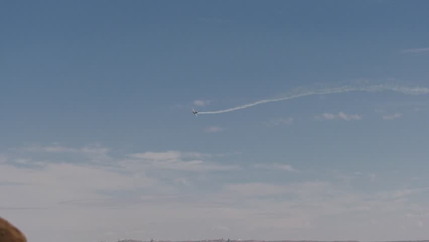 Airplanes flying by doing stunts