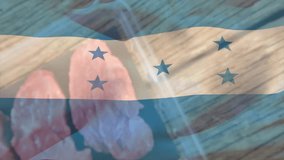 Honduras flag overlaying raw chicken pieces in plastic container on wooden surface. Patriotism, food, poultry, cuisine, packaging, cooking - Powered by Shutterstock - Get 15% off with code: PIKWIZARD15