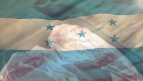 Overlaying Honduran flag on raw meat, creating animation with culinary theme. Cooking, cuisine, patriotism, heritage, culture, gastronomy - Powered by Shutterstock - Get 15% off with code: PIKWIZARD15