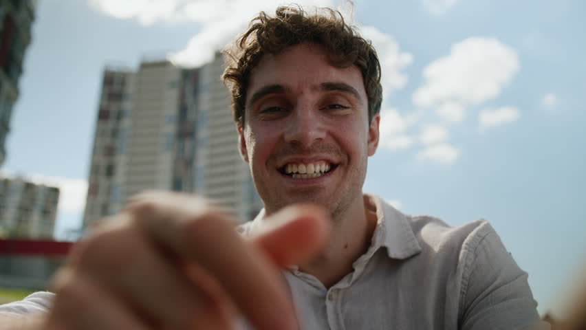 Pov happy Caucasian man using mobile phone smartphone typing message smiling laugh joyful male webcam addicted touch screen view display touchscreen cellphone gadget guy city chatting outdoor street