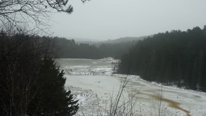 A scenic footage of a lookout at Mizzy Lake trail in Algonquin Park on a foggy winter day in Ontario, Canada