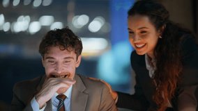Excited coworkers looking laptop screen rejoicing win in dark office closeup. Happy two colleagues rejoicing business success at night workplace. Emotional partners giving five enjoy achievement - Powered by Shutterstock - Get 15% off with code: PIKWIZARD15