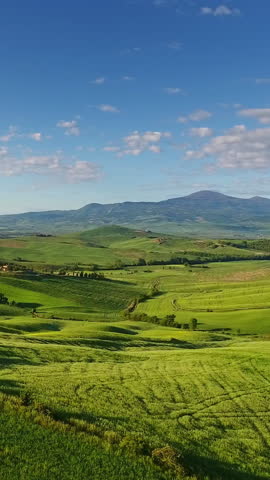 Tuscany aerial landscape of farmland hill country at evening. Italy, Europe. Vertical video