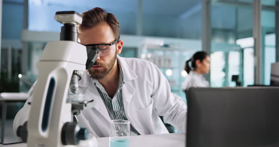 Laptop, science or man on microscope with chemical for medical experiment in lab at night. Chemistry, biotechnology or scientist with sample in glass beaker for late research, test or cure study
