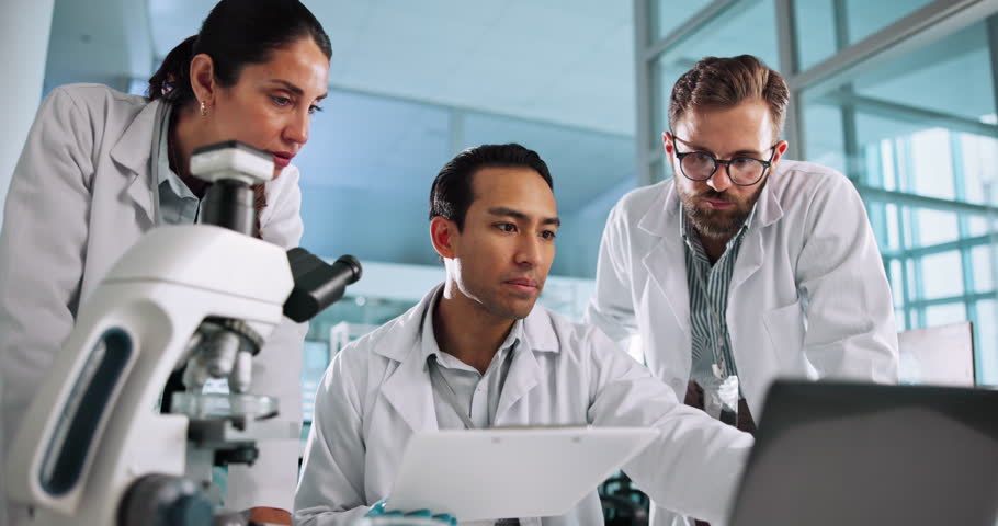 Group, scientist or people on laptop for science breakthrough, clinical trial or discovery. Low angle, medical team and checking results on technology for vaccine research, cure or development in lab