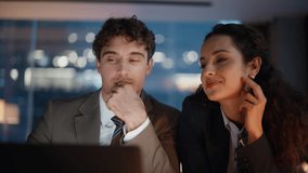 Evening office pair flirting at laptop workplace discussing work at dark room portrait. Happy coworkers enjoy friendly conversation laughing together closeup. Relaxed two charming managers talking - Powered by Shutterstock - Get 15% off with code: PIKWIZARD15