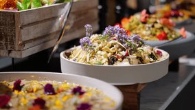 Beautifully presented gourmet salads with fresh ingredients and edible flowers at a buffet. - Powered by Shutterstock - Get 15% off with code: PIKWIZARD15