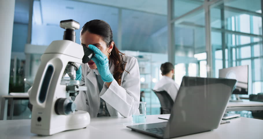 Chemical, scientist or woman with microscope for research, experiment or inspection in laboratory. Computer, chemistry or science with beaker for medical study or drugs development on laptop at night