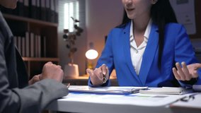 Professional businesswoman wearing blue suit explaining strategic insights during collaborative office meeting, gesturing while discussing financial reports with attentive colleague - Powered by Shutterstock - Get 15% off with code: PIKWIZARD15