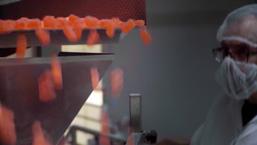 Quality control technician checking factory production with his smartphone