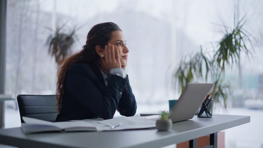 Closeup woman worker thinking on work deadline sitting light workplace. Tired businesswoman pondering project issues looking panoramic window. Unmotivated manager feeling overworked at coworking room
