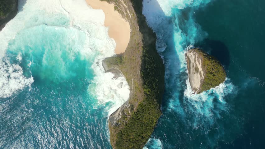 Top down view of iconic Kelingking Beach with powerful turquoise ocean and cliffs on Nusa Penida Island, Bali, Indonesia
