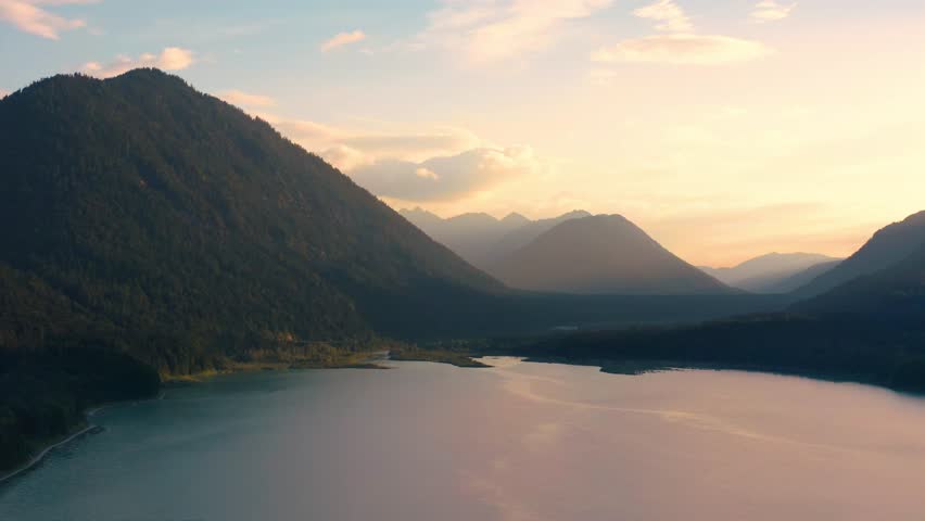 Drone aerial video at sunset with the lake Sylvenstein in Upper Bavaria, Germany
