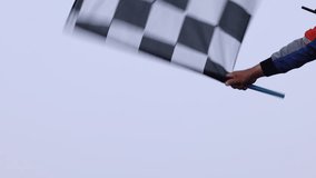 Man holding and waving checkered race flag on finish podium, Finish line and checkered flag, Race flag at the finish line on a race track, Victory achievement success motorsport. - Powered by Shutterstock - Get 15% off with code: PIKWIZARD15