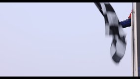 Man holding and waving checkered race flag on finish podium, Finish line and checkered flag, Race flag at the finish line on a race track, Victory achievement success motorsport. - Powered by Shutterstock - Get 15% off with code: PIKWIZARD15