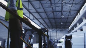 In warehouse, worker using VR headset with floating animation of social media icons. Virtual reality, technology, innovation, logistics, augmented reality, communication - Powered by Shutterstock - Get 15% off with code: PIKWIZARD15