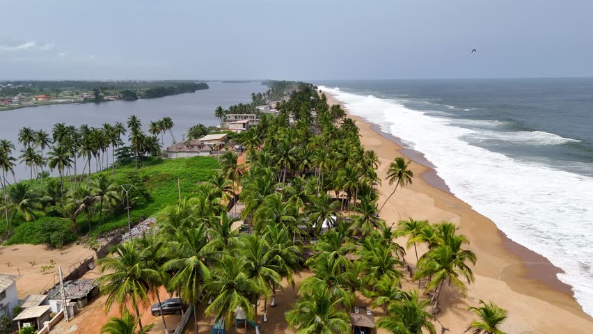 Aerial video over Grand Bassam beach in Ivory Coast, on a sunny day.