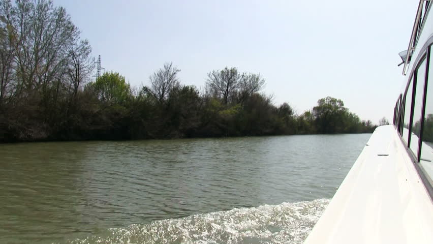 Vessel sails on the canal, view on coast, timelapse