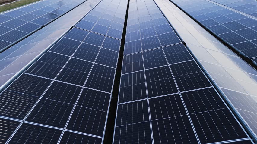 Close-up aerial shot of solar panels installed on a rooftop, capturing clean energy from sunlight. Symbol of renewable energy, sustainability, and green technology