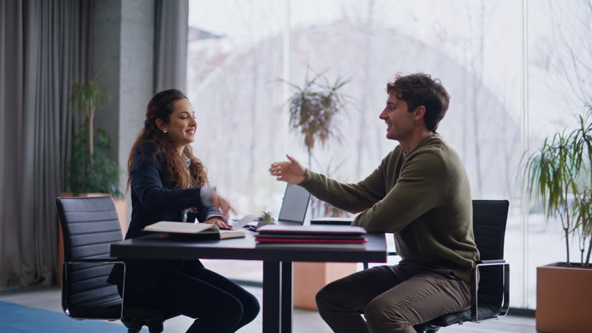 Real estate agent make consultation for client at panoramic meeting room. Business woman man customer discussing project on laptop together in big office. Successful people shaking hands making deal